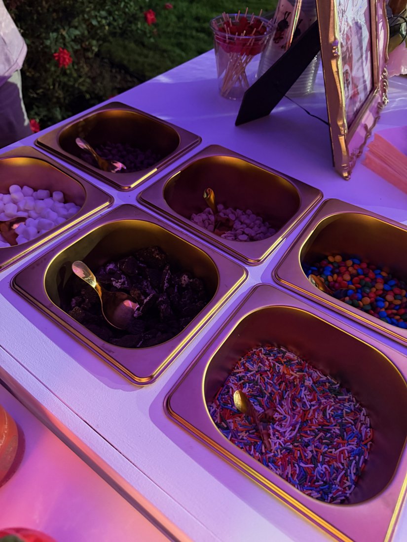 Close-up of the Berry Bougie topping bar lit in purple at an evening event