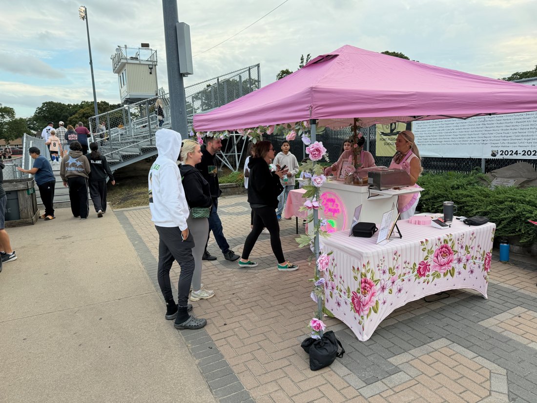 Guests lined up at the Berry Bougie tent at a school event