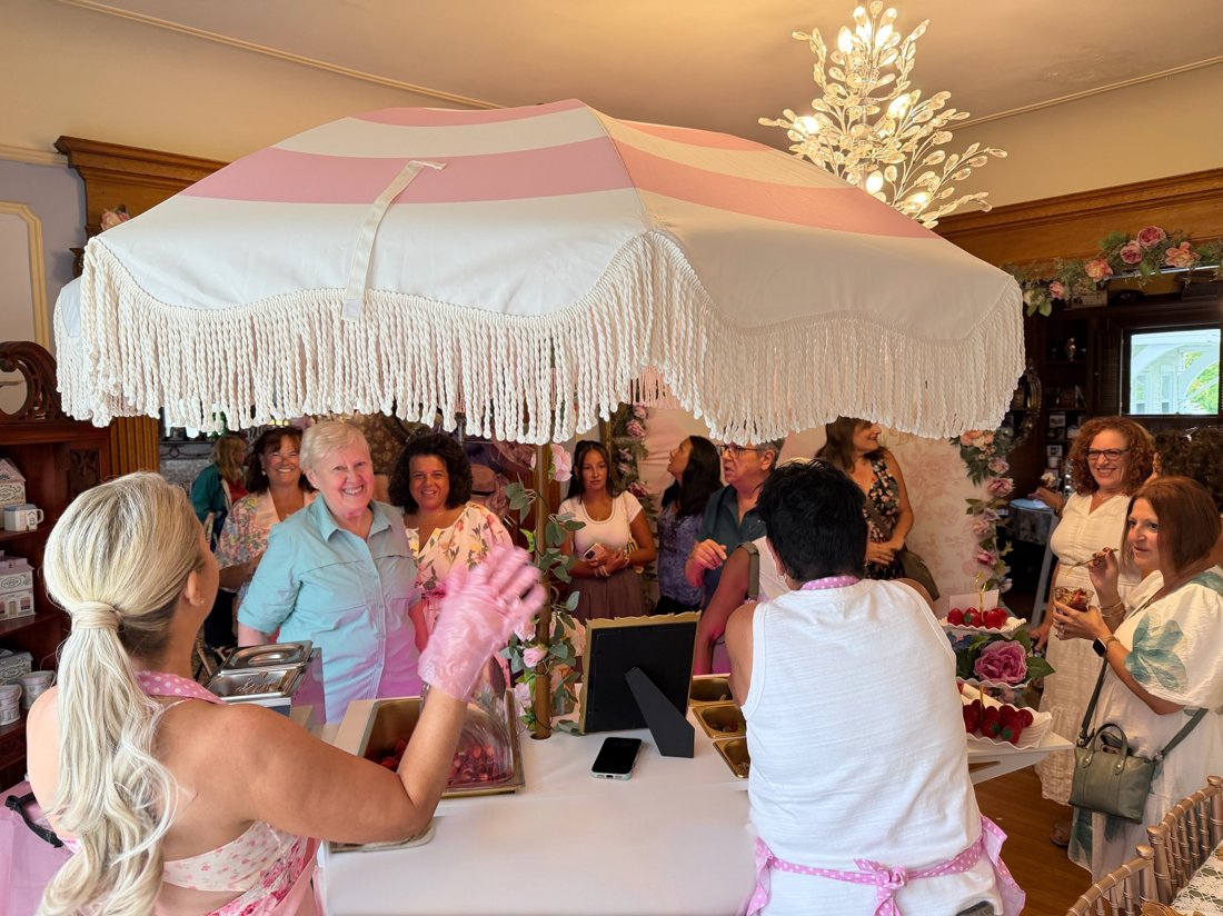 Guests gathered around the Berry Bougie cart at an indoor event