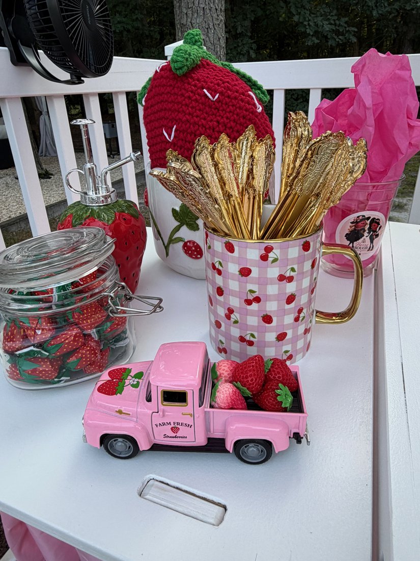 Berry Bougie styling table with strawberry truck decor and gold spoons