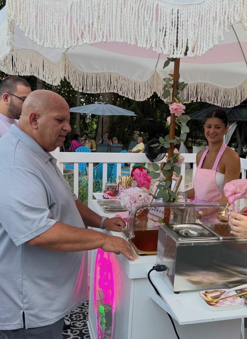 Guest being served warm chocolate at the Berry Bougie cart